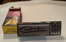 NOS 1965 Dodge Custom 880 Front Fender Nameplate Chrysler part number 2578548